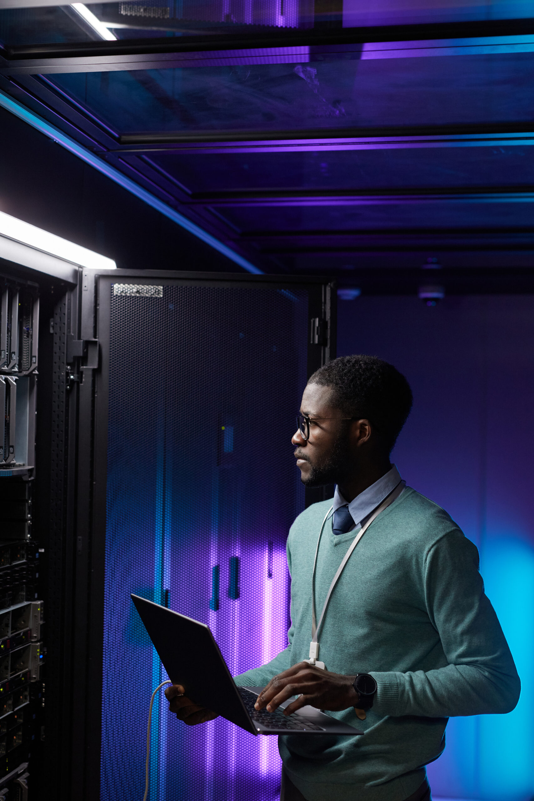 Vertical,Portrait,Of,Young,African,American,Data,Engineer,Holding,Laptop